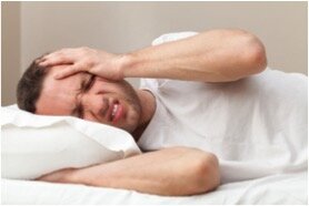 Man laying down with headache