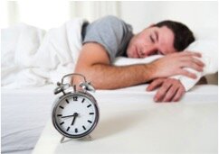 sleeping man with alarm clock