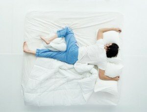 man sleeping with one leg up