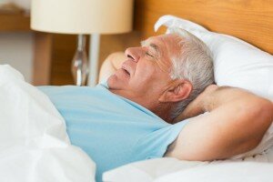 older man sleeping on back