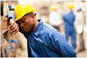 man feeling sleepy during work